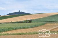 Claas mit Schneidwerkwagen